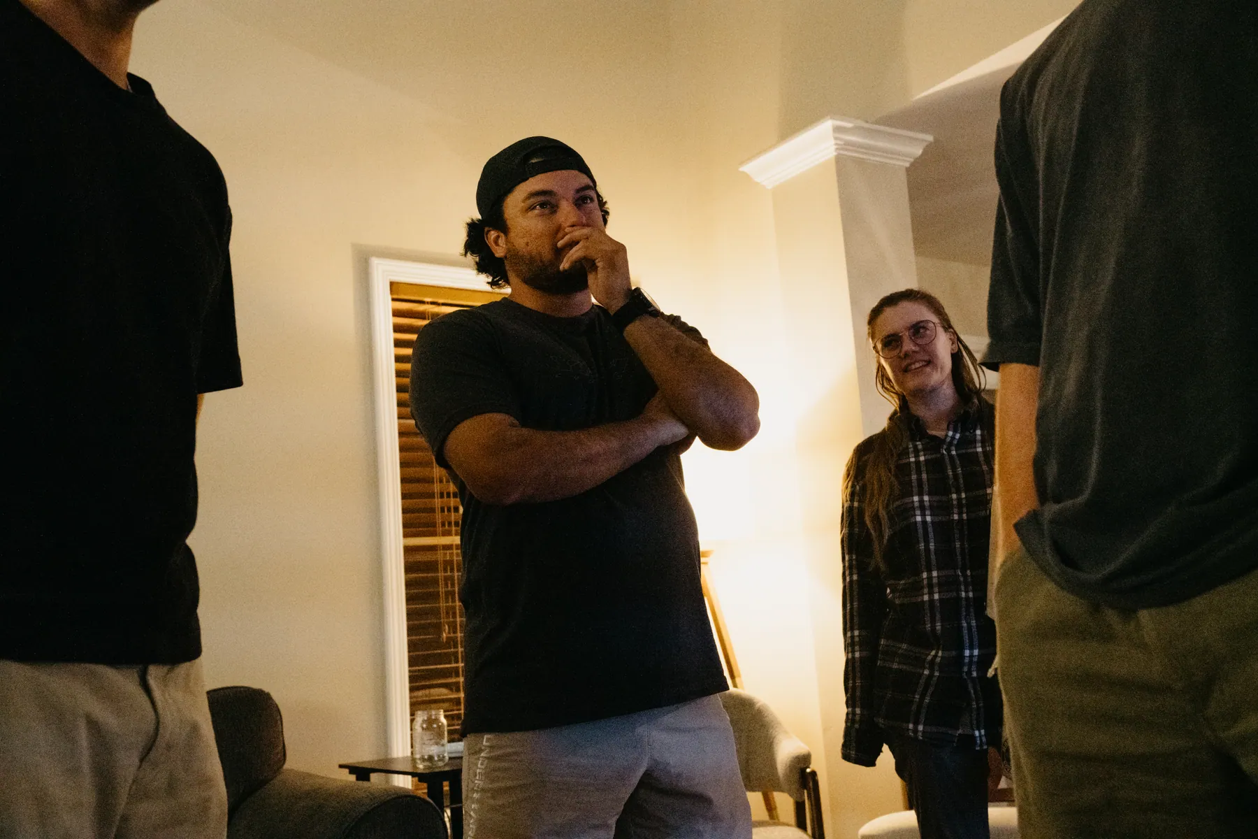 Young adults from different churches talking and laughing in the living room
